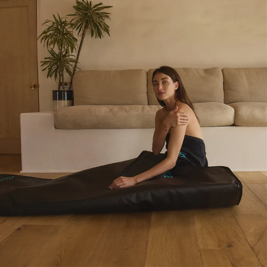 The HigherDOSE Infrared Sauna Blanket, a charcoal-grey zip-up infrared blanket laid flat.